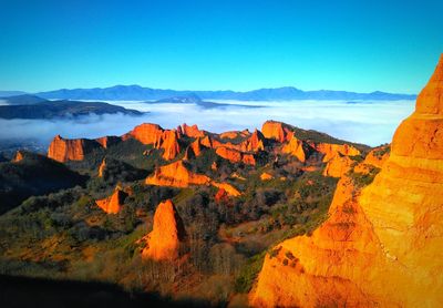 Scenic view of mountain range against blue sky and clouds sea. antique roman goldmine