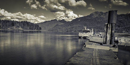 Pier over lake against mountains