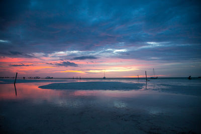 Scenic view of beach against sky during sunset