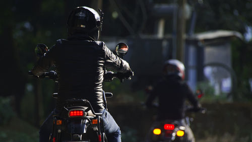 Rear view of man riding bicycle