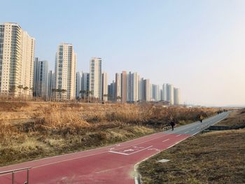 View of city buildings against clear sky