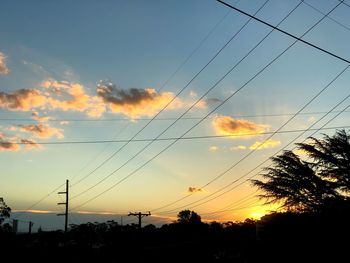 Silhouette trees against sky during sunset