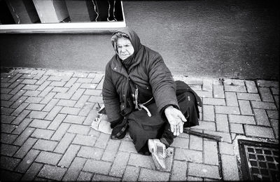 Man sitting on sidewalk