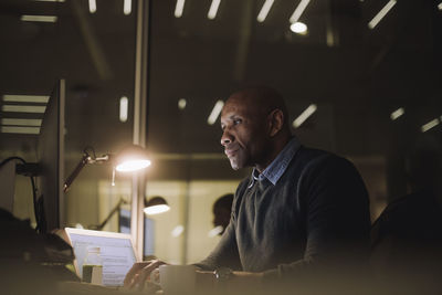 Businessman concentrating while working on computer at work place