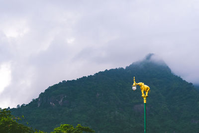 A golden elephant with a mountain background at nakhonnayok, thailand