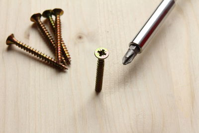 Close-up of screw on table