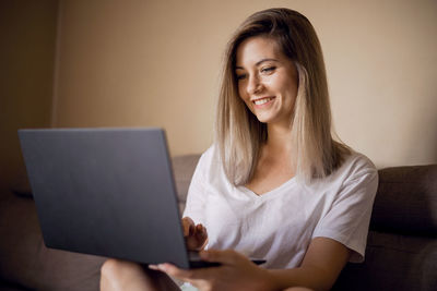 Young woman using laptop at home