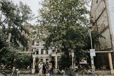 People on street against buildings in city