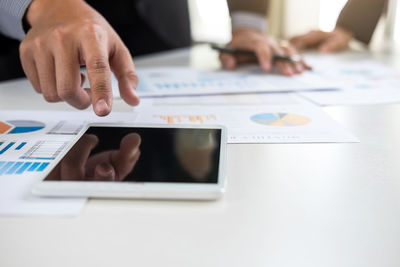 Close-up of business colleagues working in office