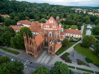 Vilnius old town and st. anne church with hill of three crosses in background. lithuania.