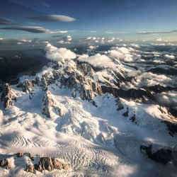 Aerial view of snowcapped mountains against sky