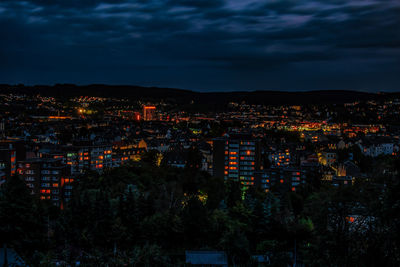 High angle view of illuminated buildings in city at night