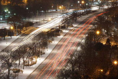 High angle view of light trails on road in winter