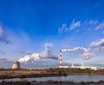 Smoke stack of factory against blue sky