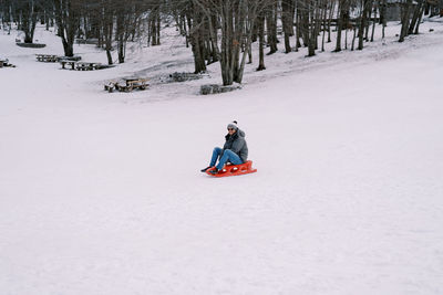 Man skiing on snow covered landscape