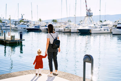 Women standing on pier with daughter