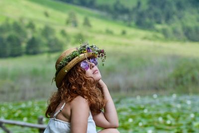 Portrait of woman against plants