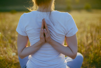 Rear view of woman practicing yoga