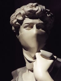 Close-up of statue against black background