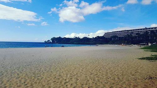 Scenic view of beach against blue sky