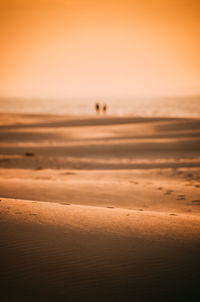 Scenic view of sea against orange sky