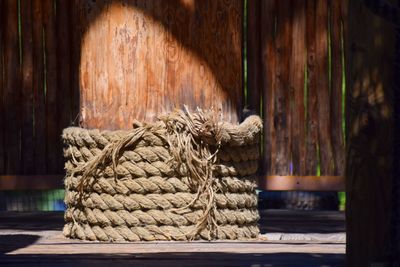 Close-up of rope tied on wooden wall