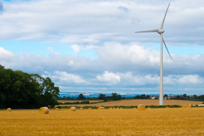 Rural landscape against cloudy sky