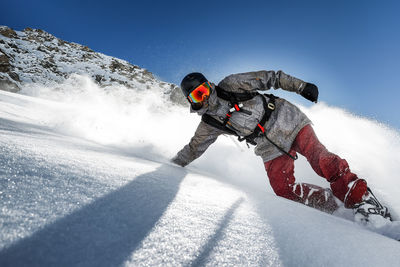 Low angle view of person skiing on snow