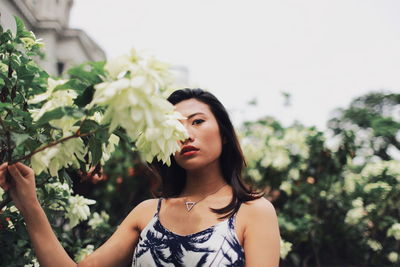 Portrait of woman against plants