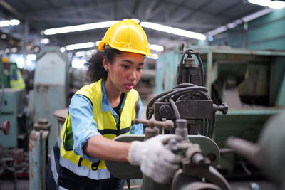 Rear view of man working in factory