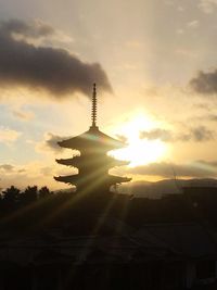 Low angle view of silhouette building against sky during sunset