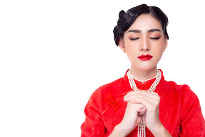 Young woman standing against white background