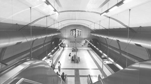 People walking on escalator in subway station