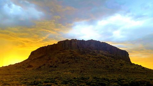 Low angle view of rock formation against sky