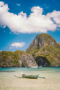 Scenic view of sea and mountains against sky