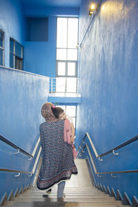 Rear view of woman on staircase