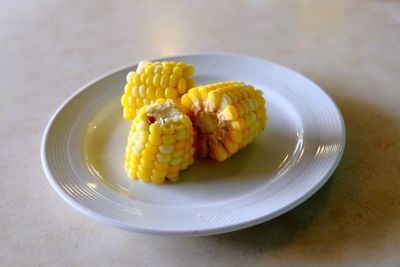 High angle view of steam corn in plate on table