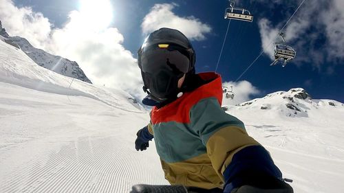 Rear view of person skiing on snow covered mountain