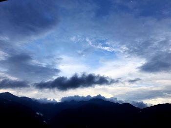 Scenic view of silhouette mountains against sky