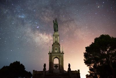 Low angle view of historic building against sky at night