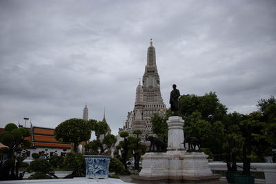 Sculpture of building against cloudy sky