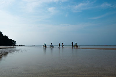 People on beach against sky