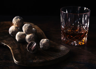 Whisky and chocolate truffles still life