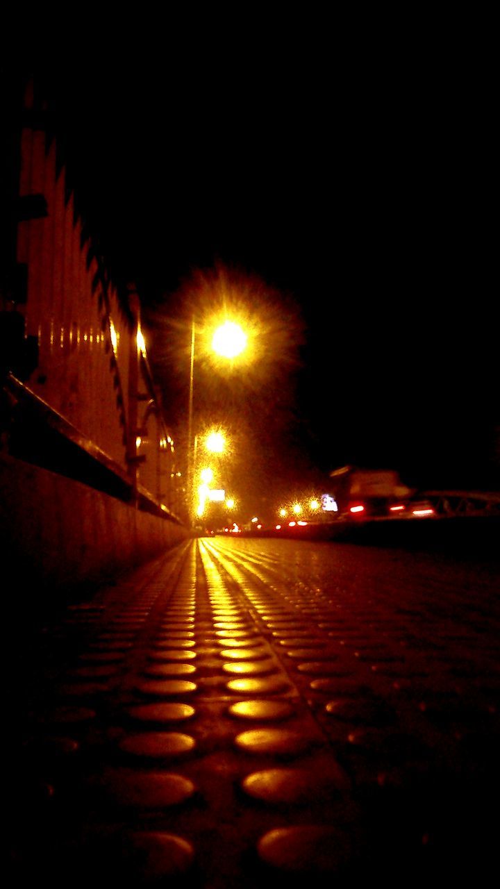 illuminated, night, the way forward, diminishing perspective, transportation, lighting equipment, street light, vanishing point, street, road, empty, built structure, architecture, long, city, light - natural phenomenon, dark, building exterior, road marking, no people