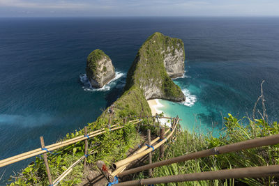 High angle view of rocks by sea against sky