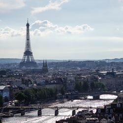 Tower and buildings in city against sky