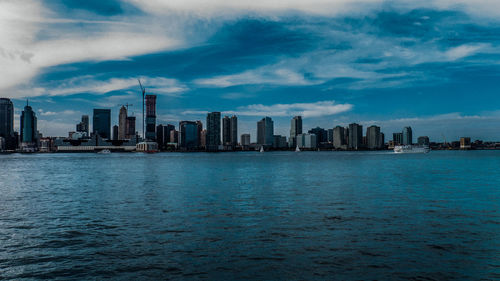 Cityscape against cloudy sky