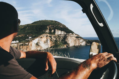 Man relaxing on rock in sea