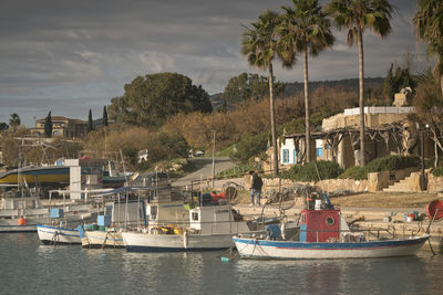 Boats moored on river against sky