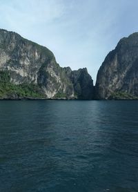 Scenic view of sea and mountains against sky